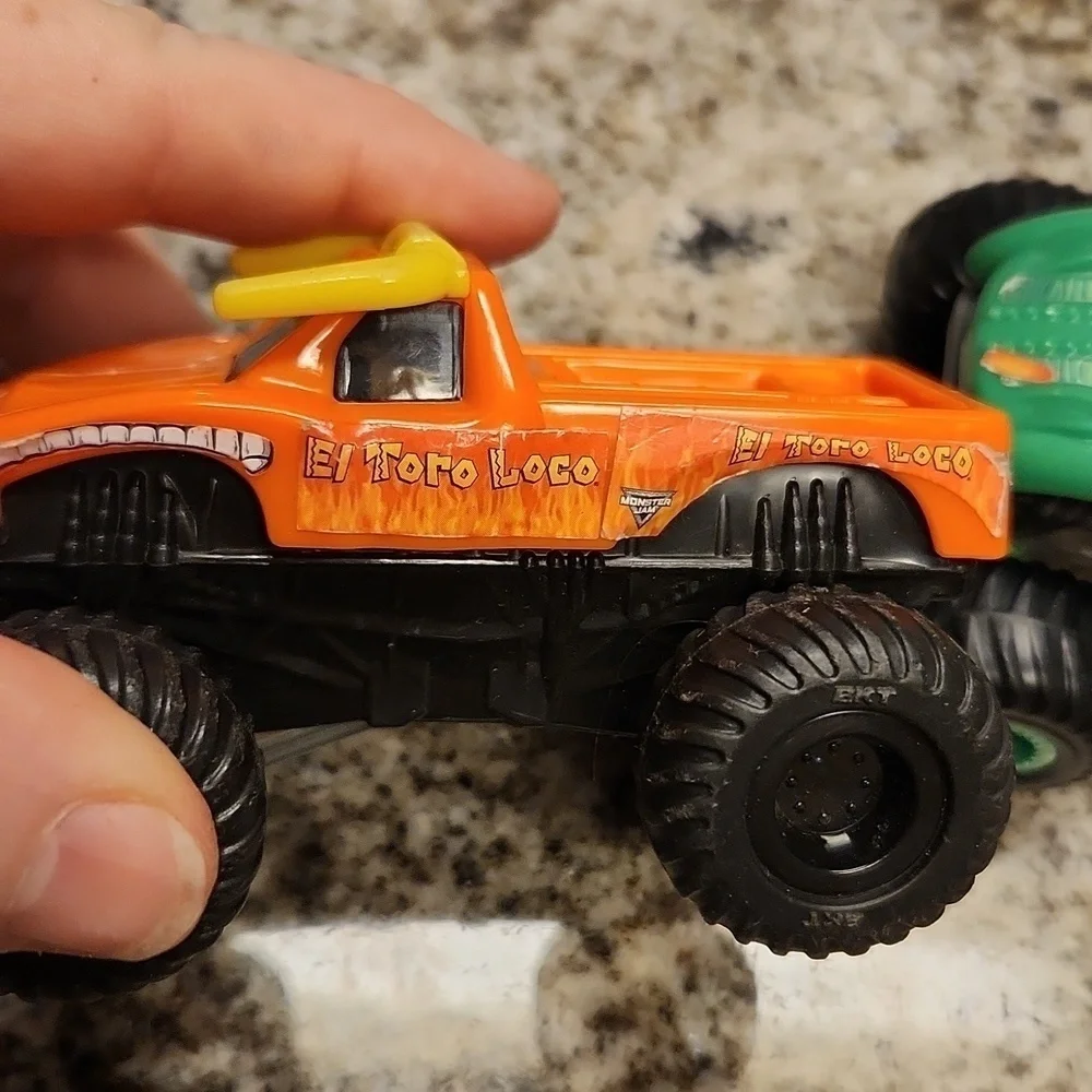 Monster jam plastic Rev up trucks has paper stickers ripping 2 cars